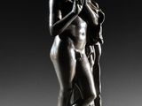 a bronze statue of a woman holding a child