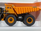 a toy dump truck that is sitting on a shelf