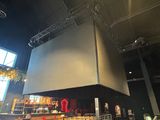 a large screen hanging from the ceiling of a building