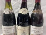 three bottles of wine are lined up on a table