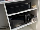 a microwave and a toaster on a shelf in a store
