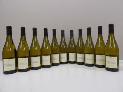 six bottles of white wine lined up in a row on a table