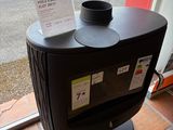 a coffee cup sitting on top of a black stove