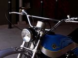 a close up of a motorcycle with a blue bag on the handlebars