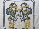 an image of a white scarf with blue and gold designs on it