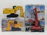 two construction vehicles that are sitting next to each other