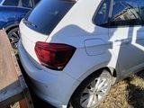 a white car that is parked next to a wooden table