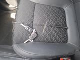 a picture of a car seat with two keys attached to it