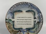 a plate with a poem on it on a stand
