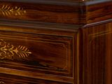 a close up of a wooden dresser with a marble top