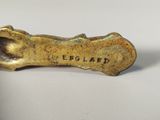 an image of a bronze figurine of a dog ' s paw with the word england written on it