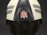 a close up of a helmet on a stand with a black background