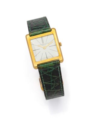 a close up of a watch on a white surface with a white background