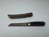 two knives that are sitting next to each other on a table