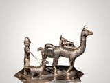 statue of a man and a woman with a camel and a man with a dog