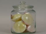 a glass jar filled with sliced onions on a white surface
