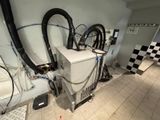 a room with a lot of appliances and wires on the wall