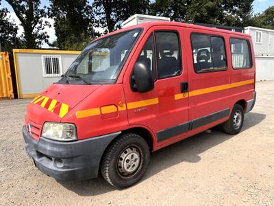 a red van that is parked in a parking lot