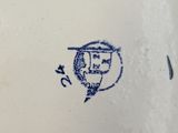 a blue and white plate with a picture of a man on it