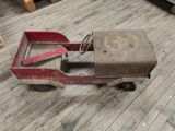 an old toy truck sitting on the floor in the room