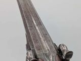 a close up of a gun that is on display on a table