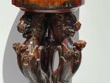 a red vase with two animals on it and a red vase with two animals on it