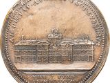 a close up of a coin with a building in the background