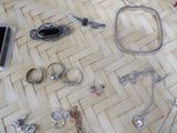 many different types of jewelry laid out on the floor