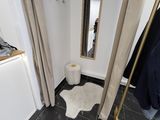 a mirror in the corner of a room with a rug on the floor