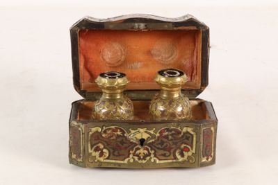 a small box with two candles inside of it