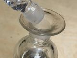a glass bottle that has a glass handle on it