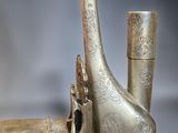 a silver and green case with a horn on it