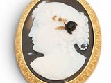 an image of a woman ' s profile in a black and white cameo broochle