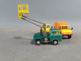 a toy truck with a crane attached to it ' s back