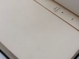 an open book sitting on top of a white table next to a cup of coffee