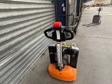 an image of a forklift parked in front of a garage