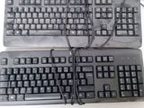 two keyboards sitting next to each other on a table