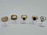 five different types of rings and tags on a white surface