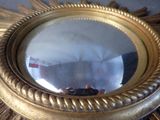 a mirror that is sitting on a table in a room