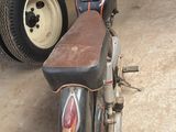 a motorcycle that is parked in a garage next to a truck