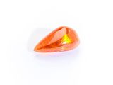 a close up of an orange quartz stone on a white surface