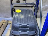 an image of a small lawn mower sitting on a pallet