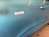 a blue car that has a sticker on the side of it