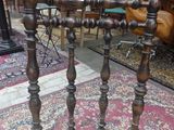 a table that has a bunch of wooden legs on it