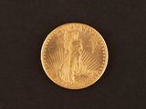 a close up of a gold coin on a black surface
