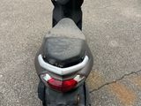 the scooter is parked in the parking lot next to the car