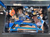 a tool box full of tools on the sidewalk