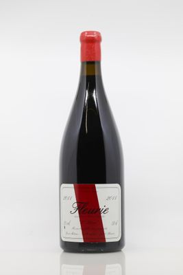 a bottle of red wine sitting on top of a white table
