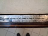 a close up of a knife with writing on it