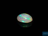 a white oplite in the dark with a black background
